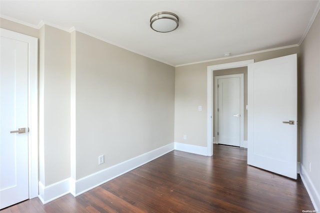 unfurnished room featuring crown molding and dark wood-type flooring