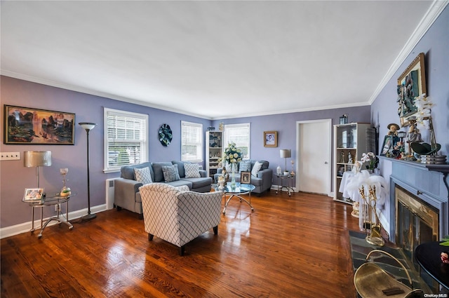 living room with dark hardwood / wood-style floors, a stone fireplace, and crown molding