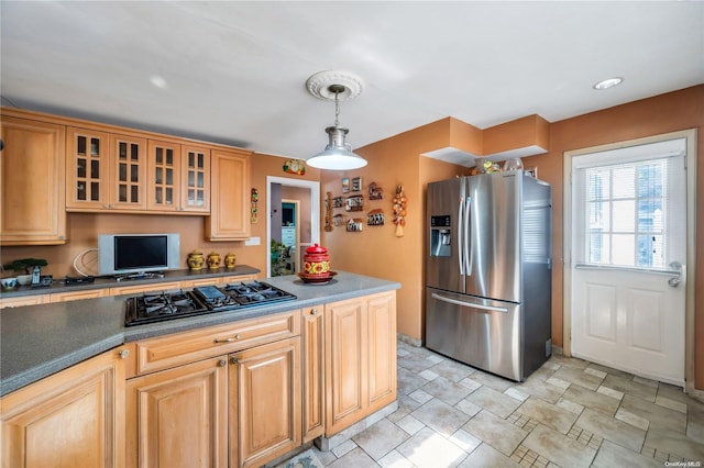 kitchen with pendant lighting, stainless steel fridge with ice dispenser, and black gas cooktop