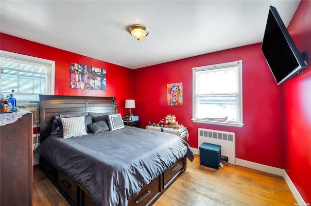 bedroom featuring light hardwood / wood-style floors and radiator