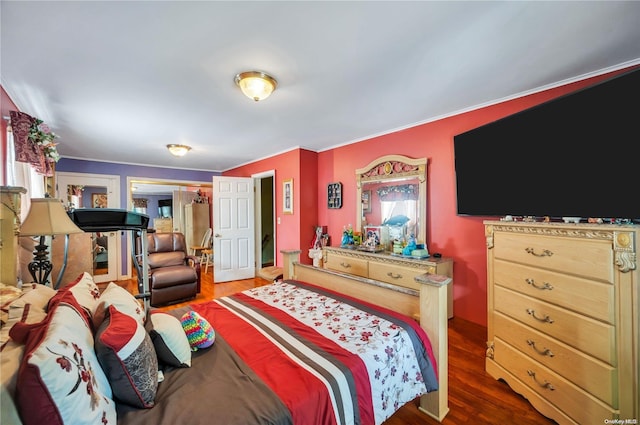 bedroom with dark hardwood / wood-style floors and ornamental molding