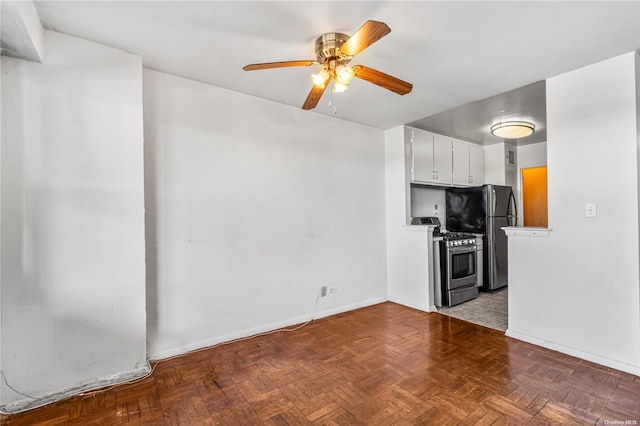 kitchen with white cabinets, appliances with stainless steel finishes, light parquet floors, and ceiling fan