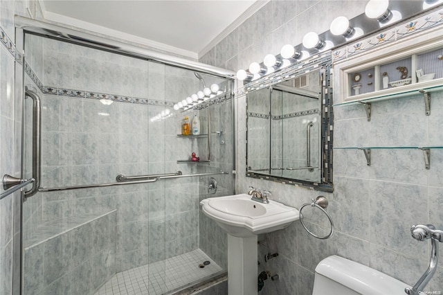 17-85 215th St Unit 6R, Bayside, NY 11360 - bathroom featuring a stall shower, toilet, tile walls, and a sink