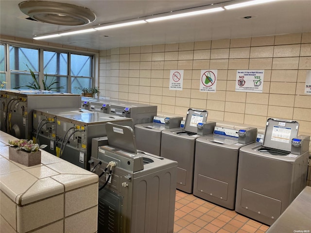 17-85 215th St Unit 6R, Bayside, NY 11360 - community laundry room featuring washer / dryer, light tile patterned flooring, and tile walls