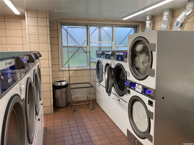 17-85 215th St Unit 6R, Bayside, NY 11360 - community laundry featuring stacked washer and clothes dryer, washing machine and dryer, tile patterned flooring, tile walls, and healthy amount of natural light