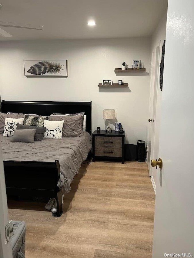 bedroom featuring ceiling fan and light hardwood / wood-style floors