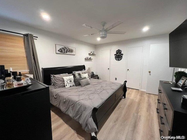 bedroom featuring light wood-type flooring and ceiling fan