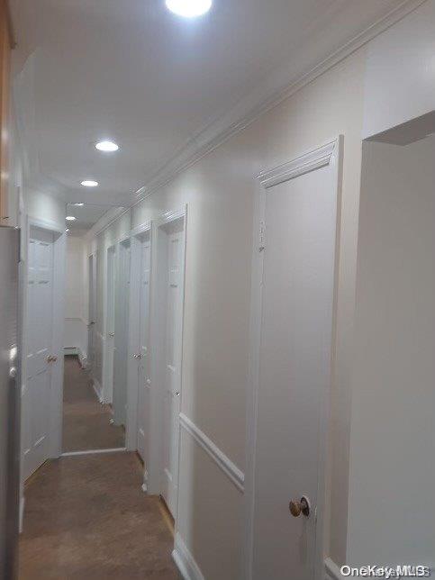 hallway featuring crown molding