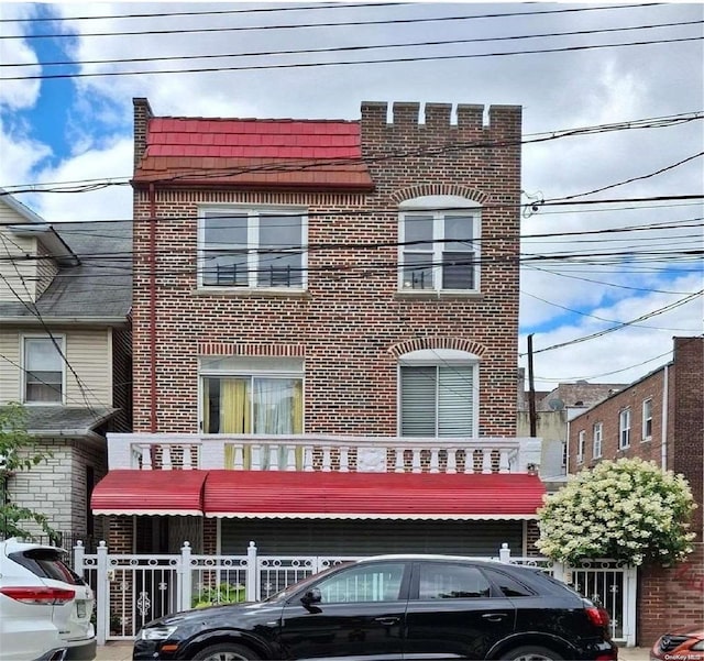 view of front of house featuring a balcony