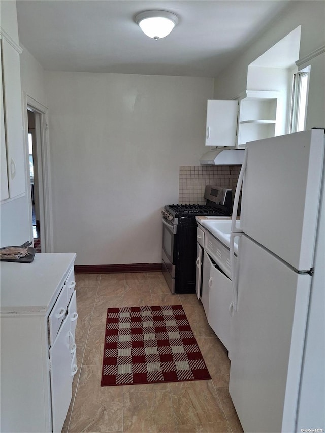 kitchen featuring white cabinetry, stainless steel gas stove, range hood, white refrigerator, and backsplash