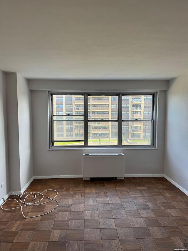 spare room featuring radiator heating unit