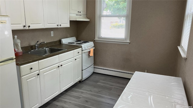 kitchen with white cabinets, white appliances, sink, and a baseboard heating unit