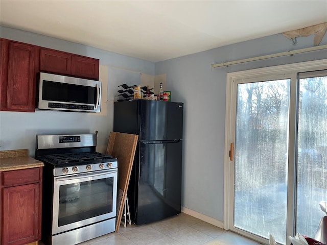 kitchen with stainless steel appliances and light tile patterned floors