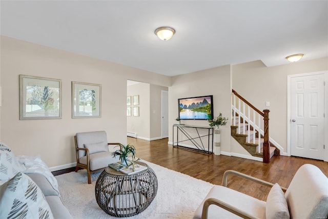 living room with baseboard heating and dark wood-type flooring