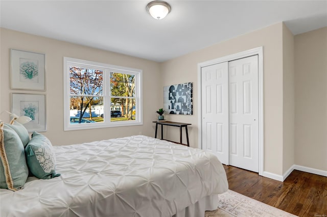 bedroom featuring dark hardwood / wood-style flooring and a closet