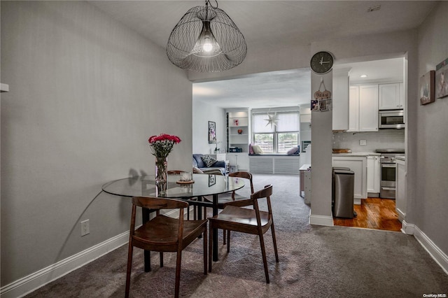 dining space featuring dark hardwood / wood-style flooring