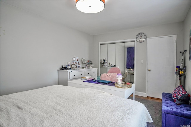 bedroom with a closet and dark wood-type flooring