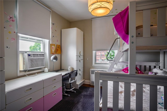 carpeted bedroom with cooling unit and radiator heating unit