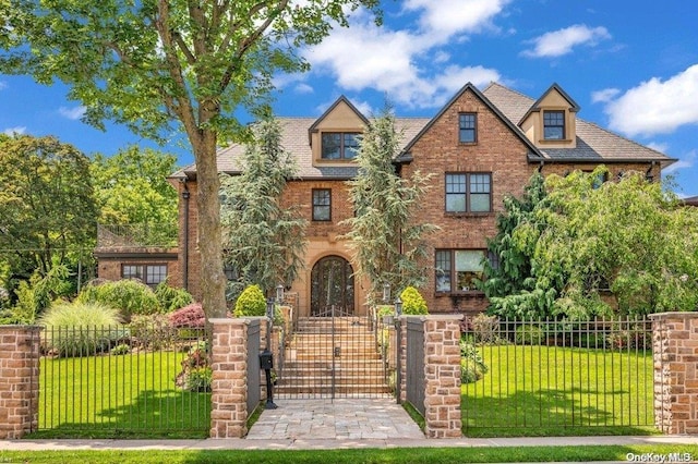 tudor home with a front yard