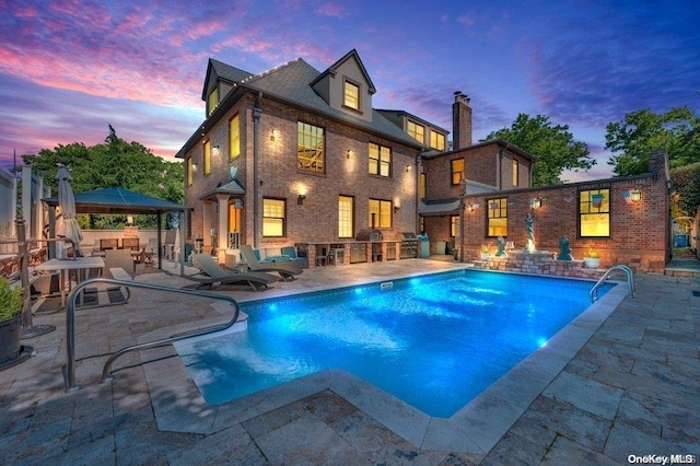 262 Howard Ave, Staten Island, NY 10301 - pool at dusk featuring a gazebo, a patio area, an outdoor pool, and exterior kitchen