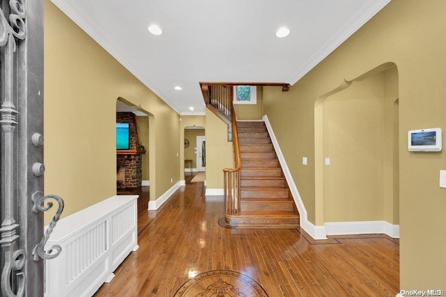 262 Howard Ave, Staten Island, NY 10301 - entrance foyer with arched walkways, crown molding, wood finished floors, baseboards, and stairs