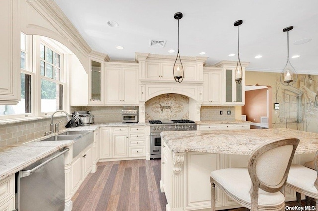 262 Howard Ave, Staten Island, NY 10301 - kitchen featuring appliances with stainless steel finishes, a sink, light stone countertops, light wood-type flooring, and tasteful backsplash
