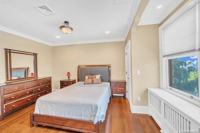 262 Howard Ave, Staten Island, NY 10301 - bedroom with radiator heating unit, wood finished floors, crown molding, recessed lighting, and baseboards