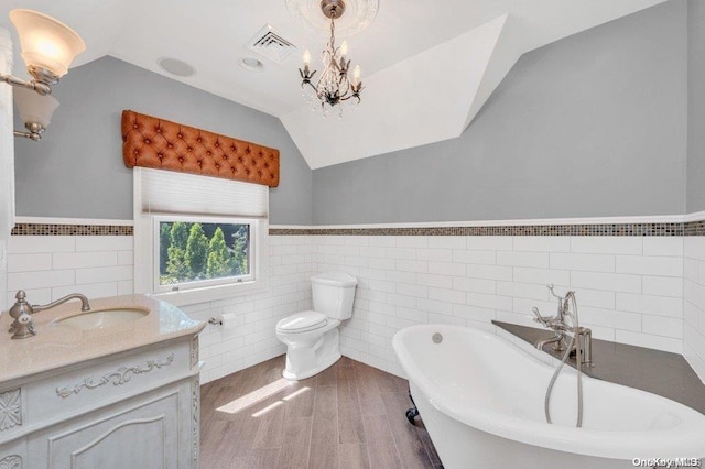 262 Howard Ave, Staten Island, NY 10301 - full bath with lofted ceiling, a soaking tub, tile walls, wood finished floors, and wainscoting