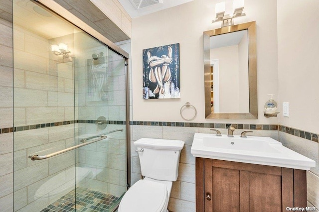 262 Howard Ave, Staten Island, NY 10301 - bathroom featuring toilet, vanity, tile walls, wainscoting, and a stall shower