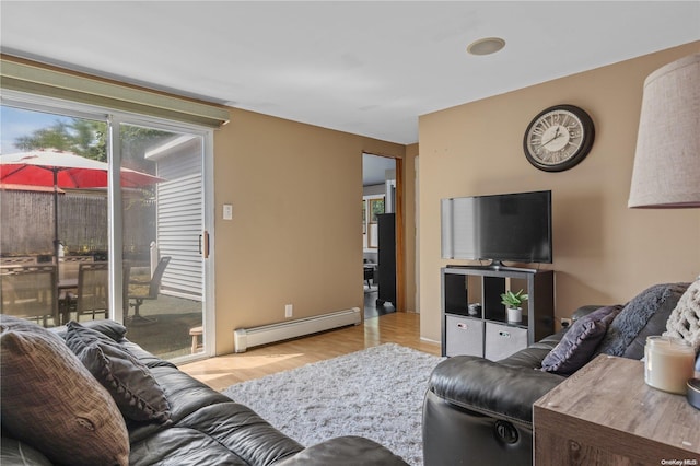 living room with light hardwood / wood-style flooring and a baseboard heating unit