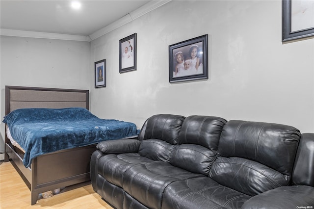 bedroom with wood-type flooring and ornamental molding