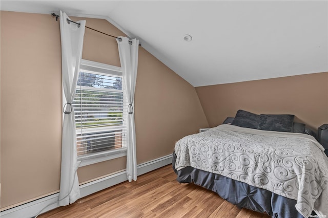 bedroom with light hardwood / wood-style floors and lofted ceiling