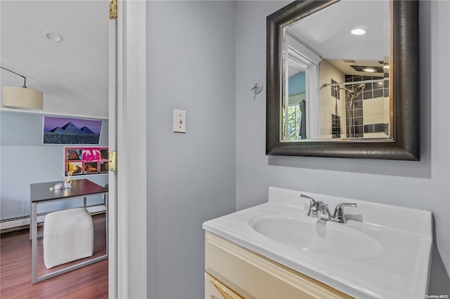 bathroom with hardwood / wood-style floors and vanity