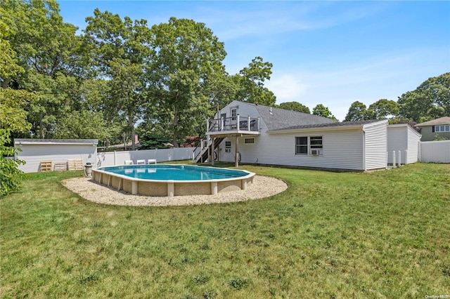 view of swimming pool with a yard and a deck