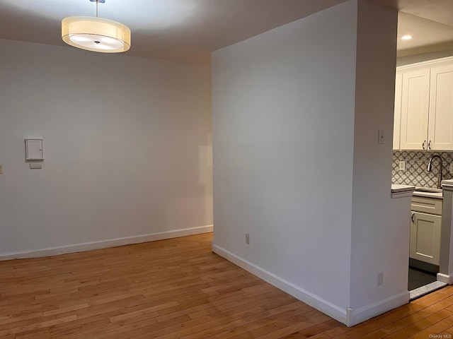 interior space with sink and light hardwood / wood-style flooring