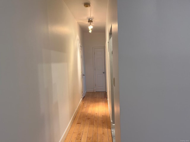 hallway with light hardwood / wood-style flooring