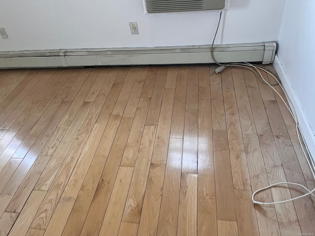 room details featuring hardwood / wood-style flooring and a baseboard heating unit