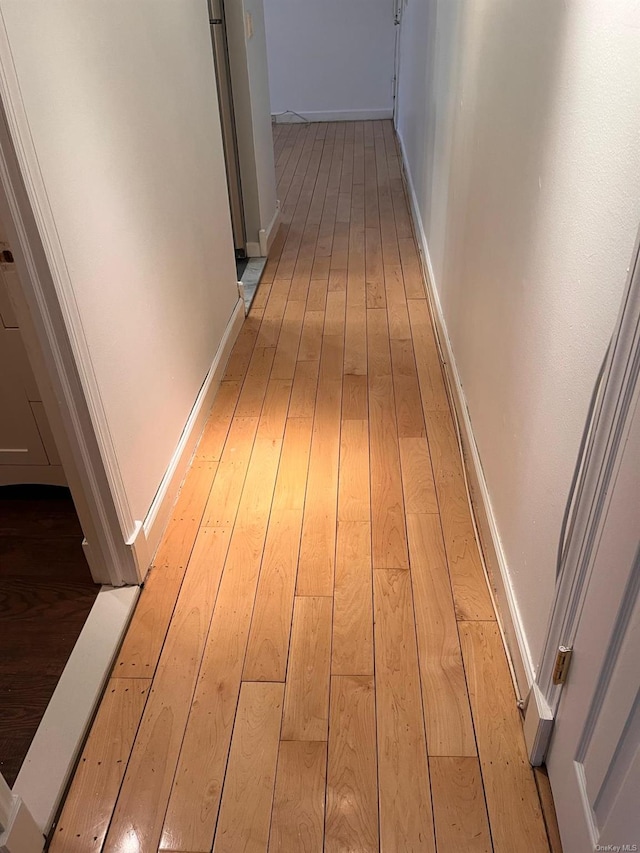 corridor with light wood-type flooring