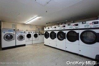 clothes washing area featuring independent washer and dryer