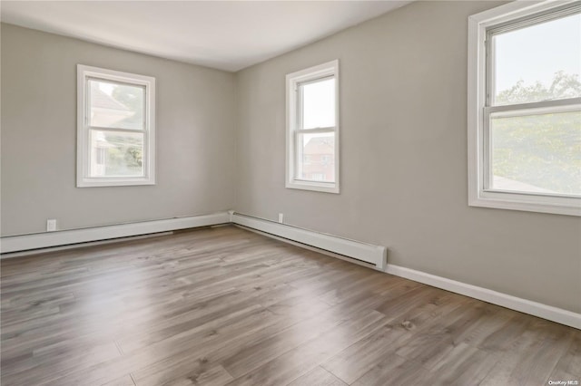 unfurnished room with plenty of natural light and light hardwood / wood-style flooring