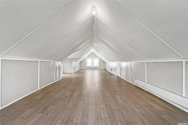 bonus room featuring hardwood / wood-style floors, vaulted ceiling, and a baseboard heating unit