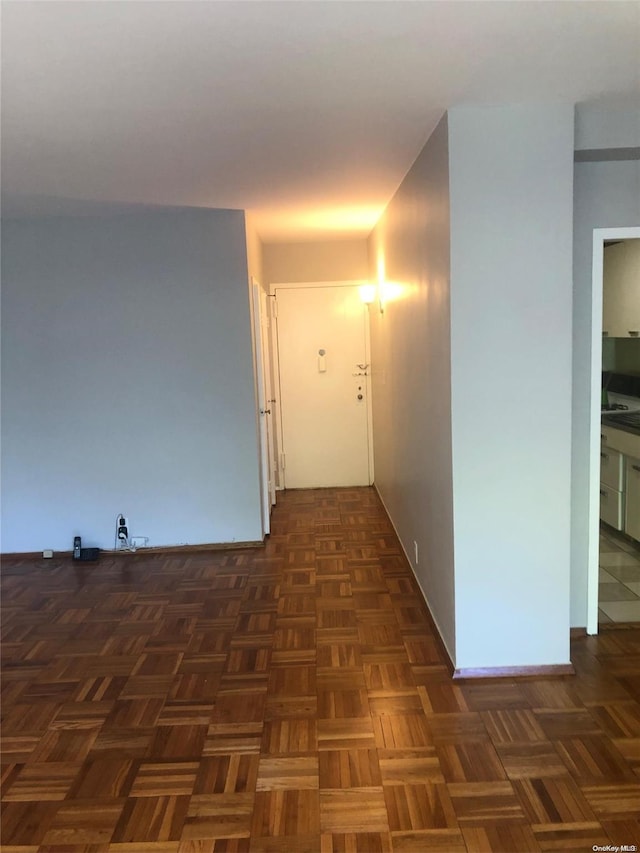 corridor featuring dark parquet flooring