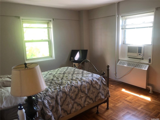 bedroom with parquet flooring and radiator heating unit