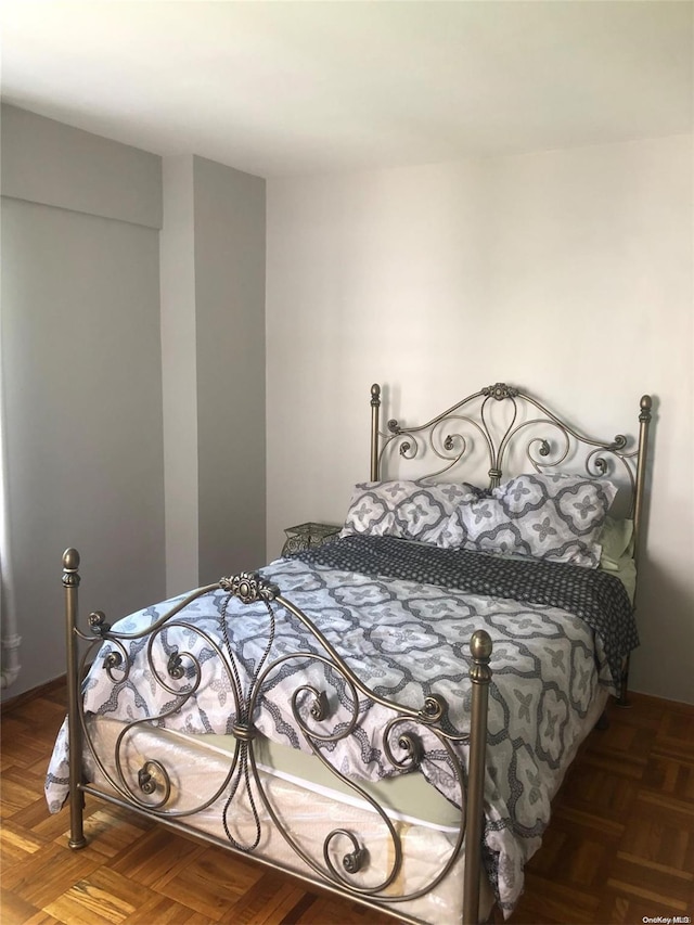 bedroom featuring dark parquet floors