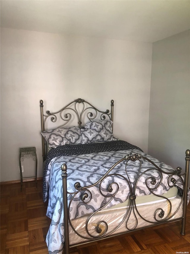 bedroom featuring dark parquet flooring