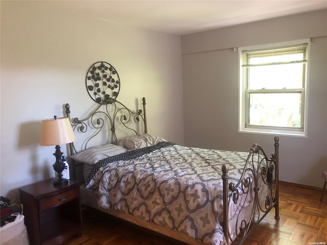 bedroom with dark parquet floors