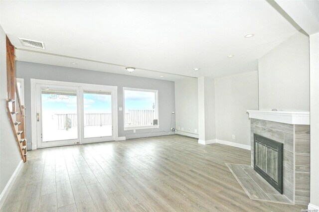 190 Bayview Ave, Lindenhurst, NY 11757 - unfurnished living room featuring stairway, baseboards, plenty of natural light, light wood-type flooring, and recessed lighting