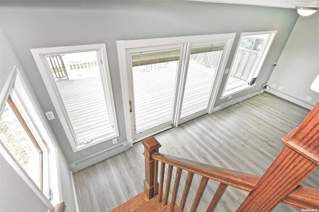 190 Bayview Ave, Lindenhurst, NY 11757 - staircase featuring wood finished floors and a baseboard heating unit