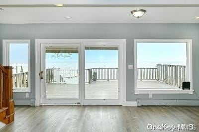 190 Bayview Ave, Lindenhurst, NY 11757 - doorway to outside featuring wood finished floors