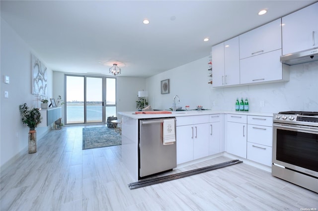 kitchen featuring kitchen peninsula, white cabinets, a water view, and appliances with stainless steel finishes